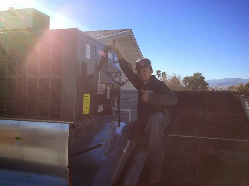 HVAC technician performing AC Tune-Up on a rooftop unit in Bordentown